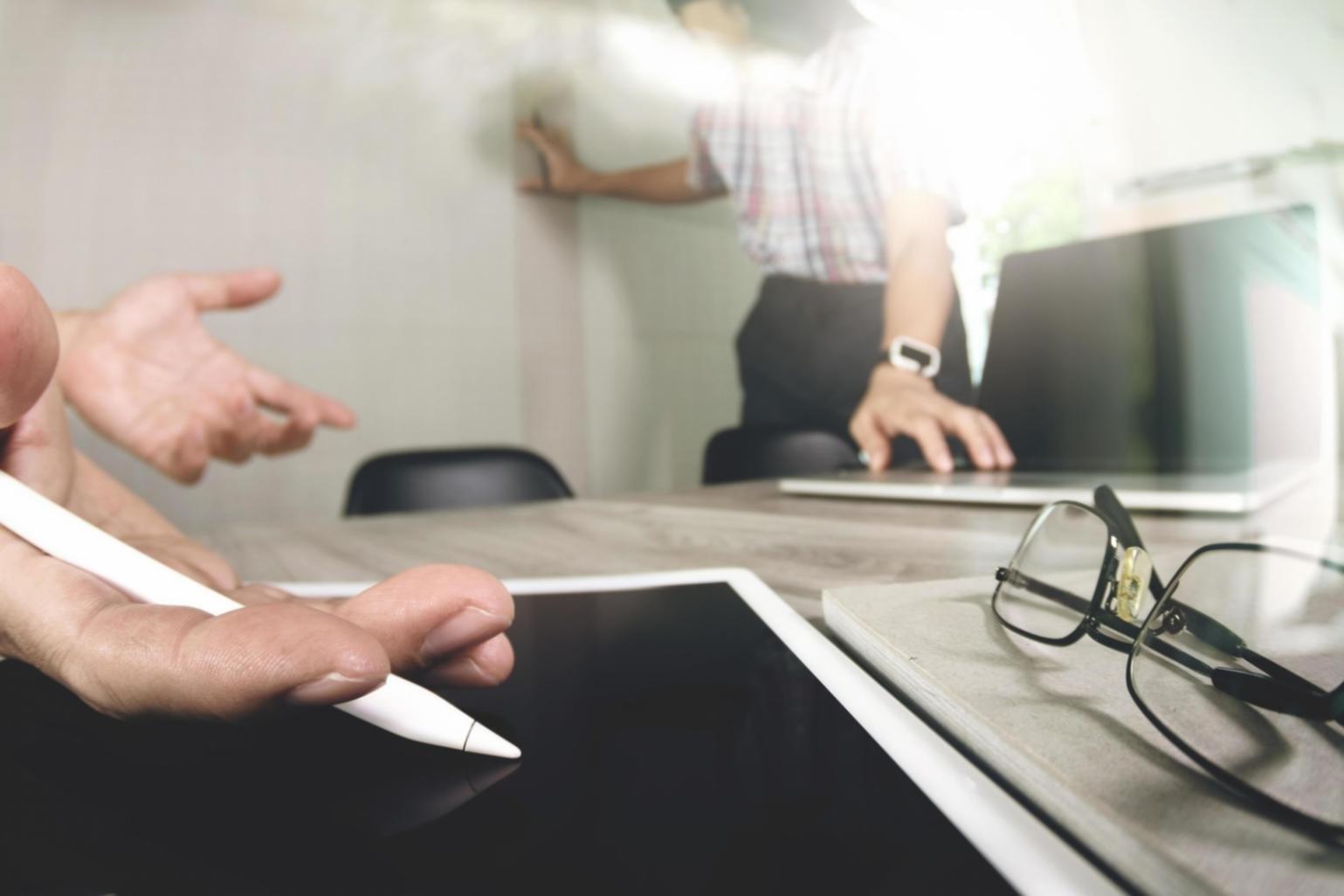 Modern office workspace showing invoice processing workflow